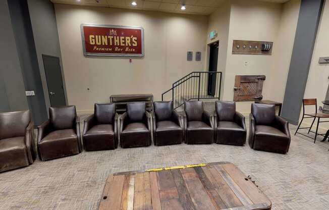 a waiting room with leather chairs and a table