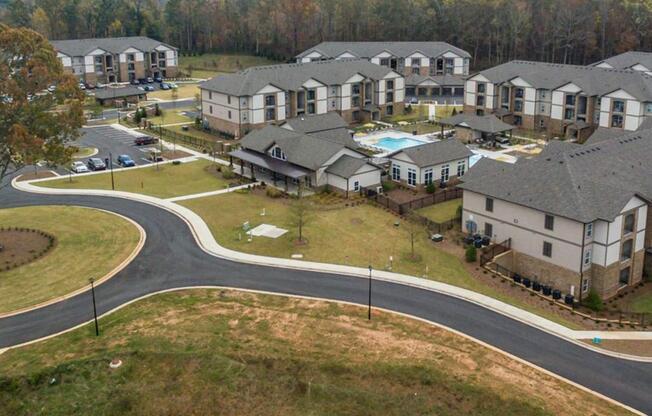 Aerial view of One White Oak apartment grounds and city view in Cumming, GA rentals