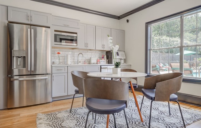 Clubhouse kitchen area grey cabinets stainless steel fridge large window