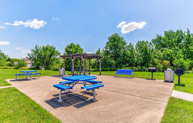 a picnic area with benches and a gazebo