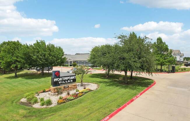 A sign for Northpoint Villas is in the middle of a landscaped area.