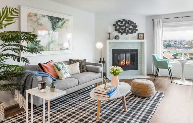 a living room with a couch and a fireplace   and a table