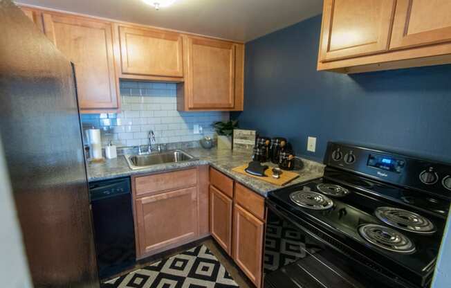 This is a picture of the kitchen in an upgraded 980 square foot, 2 bedroom, 1 bath model apartment at Fairfield Pointe Apartments in Fairfield, Ohio.