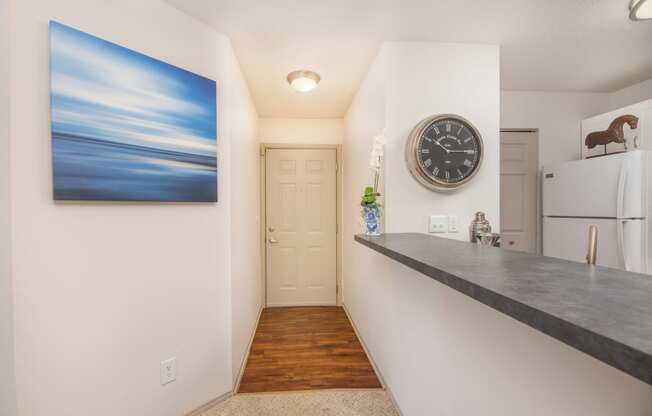 a kitchen with a counter and a clock on the wall and a refrigerator at Butternut Ridge, Ohio