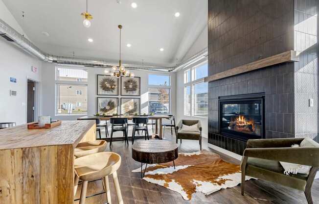A modern living room with a fireplace and a cowhide rug.