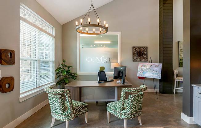 an office with two chairs and a desk with a computer