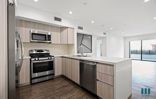 Kitchen with Energy-Efficient Stainless Appliances and Countertop Bar