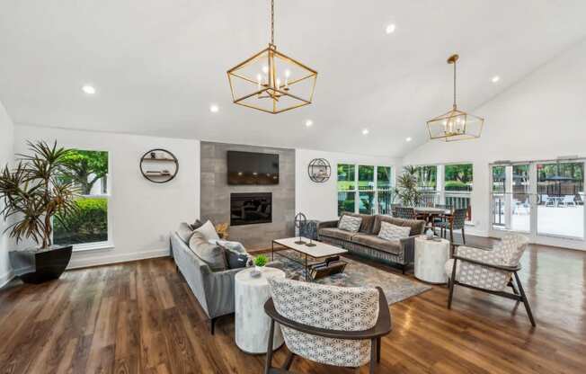 A living room with a grey couch, a coffee table, and a fireplace.