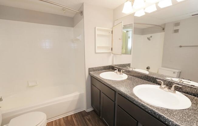 a bathroom with two sinks and a bathtub