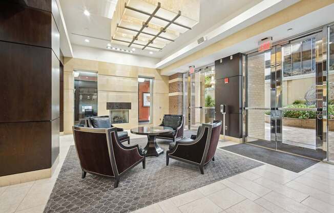 A modern waiting area with brown chairs and a glass door.