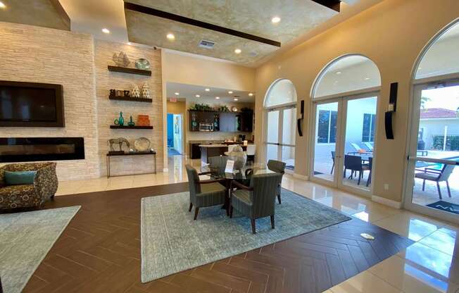A large, well-lit living room with a dining table and chairs.