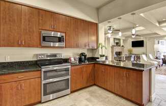 a kitchen with wood cabinets and stainless steel appliances
