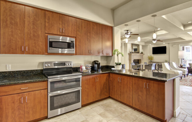 a kitchen with wood cabinets and stainless steel appliances