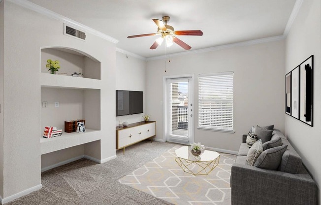 a living room with a ceiling fan and a window