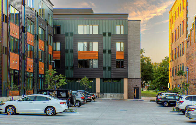 a city street with cars parked in front of a building at Canary Lofts, Des Moines, 50311
