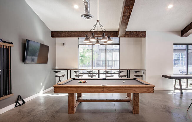 Clubhouse pool table, bar seating and wall tv