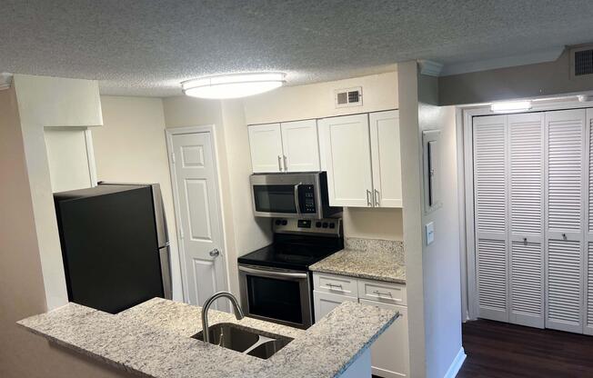 a kitchen with a stove top oven sitting inside of a room