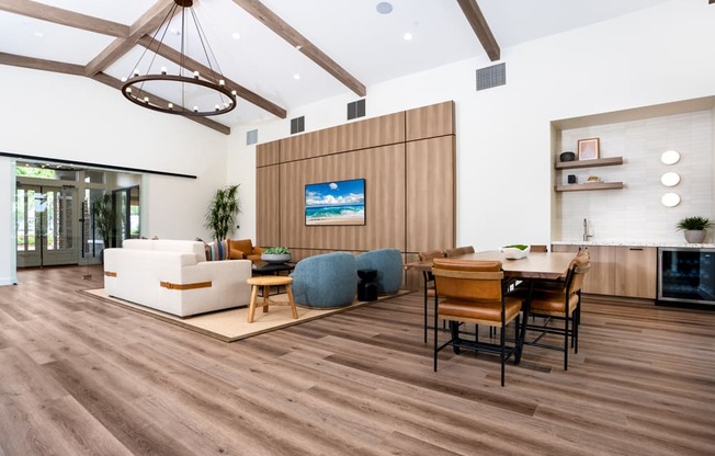 a living room and dining room with wooden floors and a table and chairs