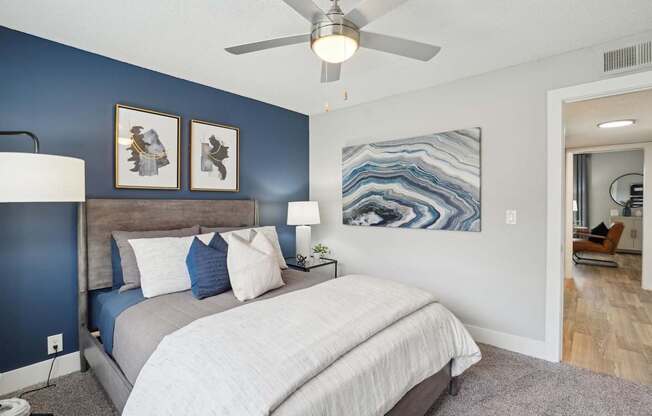 Cozy bedroom with plush carpeting and large windows at Reserve at Drakes Creek