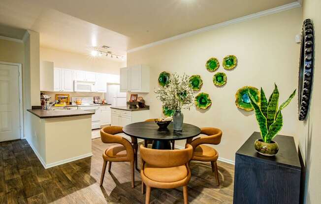 A kitchen with a table and chairs in the middle of the room.