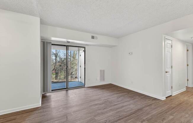 A room with a sliding glass door leading outside.