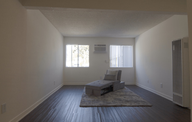 A large bedroom with a bed and a chair.