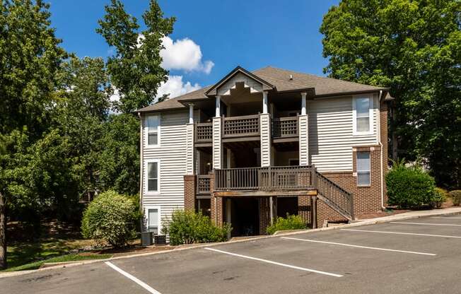 the view of a apartment building with a parking lot