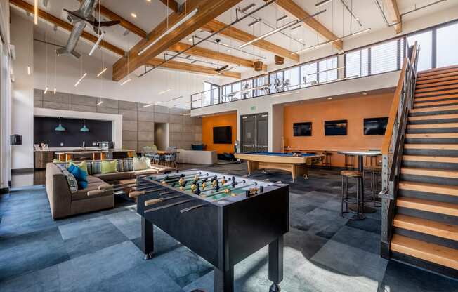 a game room with a foosball table and a ping pong table
