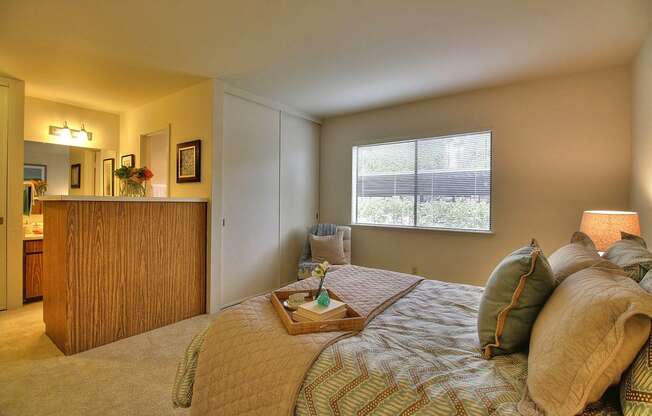 a bedroom with a bed and a dresser and a window