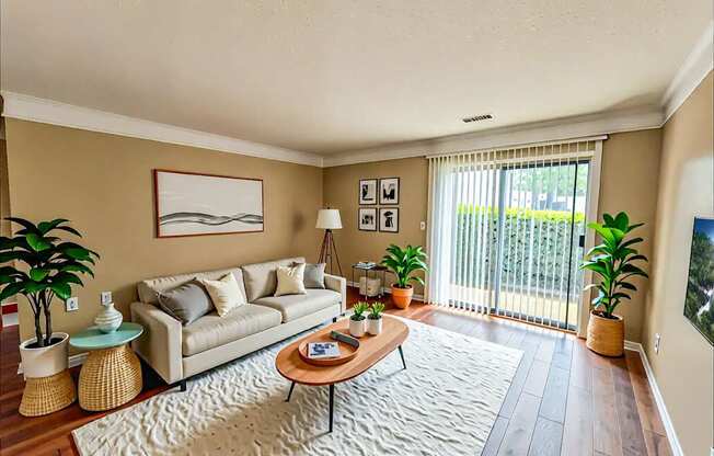 A living room with a couch, a coffee table, and a painting on the wall.