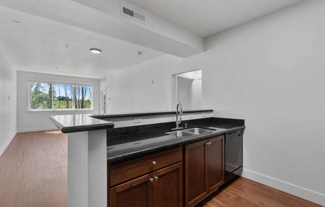 a kitchen with dark wood cabinets and granite countertops