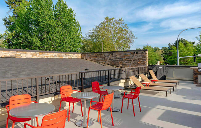 a patio with tables and chairs and a brick wall at Delano, Washington, 98052