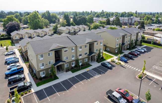 A parking lot in front of apartment buildings.