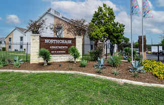 the entrance to northeast apartments sign in front of a fence