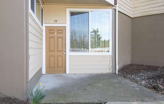 the front door of a home with a porch