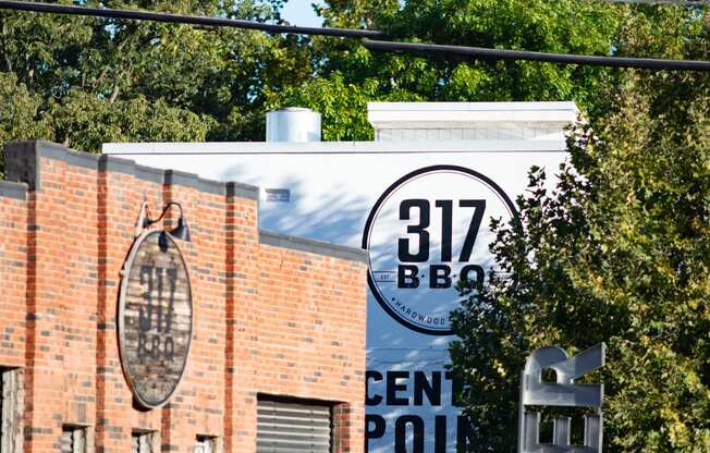 a sign that reads 312 bee in front of a brick building