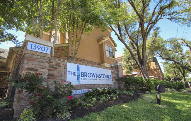 This is a photo of the entrance sign at The Brownstones Townhome Apartments in Dallas, TX.