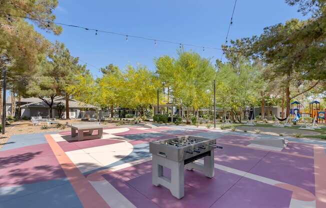 a park with a ping pong table and benches at Paisley and Pointe Apartments, Nevada, 89130