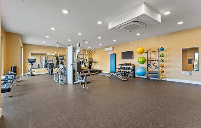 A spacious gym with a variety of exercise equipment.