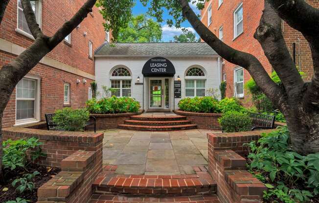 front entrance with trees and brick walkway