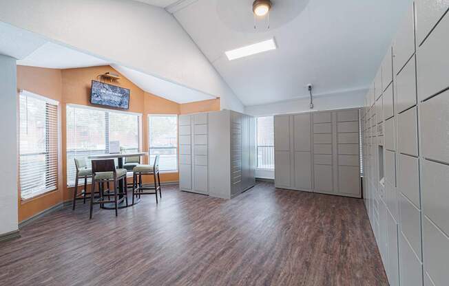 A room with wooden floors and a television mounted on the wall.