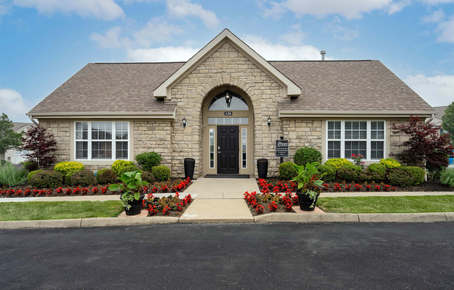 A house with a grey roof and a black door.