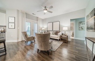 a living room with furniture and a ceiling fan