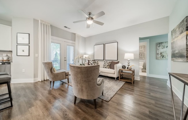 a living room with furniture and a ceiling fan