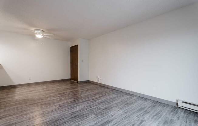 A room with a wooden floor and a brown door. at Bristol Ridge, Iowa, 50322