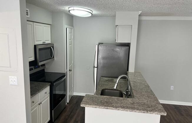 a kitchen with a sink and a mirror