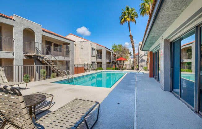 our apartments have a swimming pool and a patio with chairs