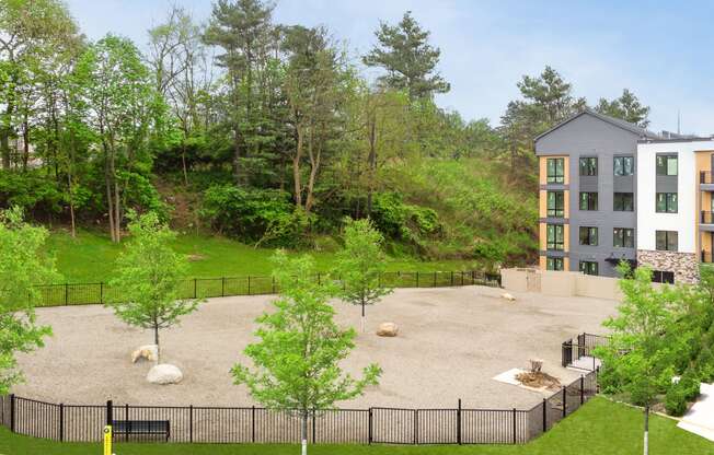 an aerial view of the courtyard of an apartment building with a playground and trees