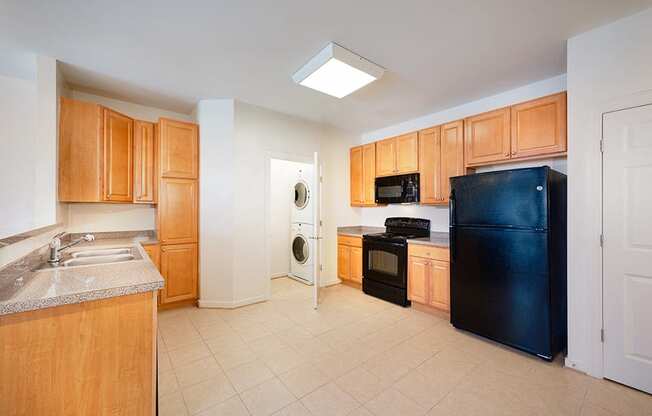 a kitchen with black appliances and wooden cabinets