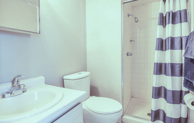 a bathroom with a sink toilet and shower